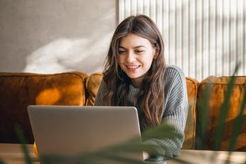 Frontend attractive young woman working laptop early morning